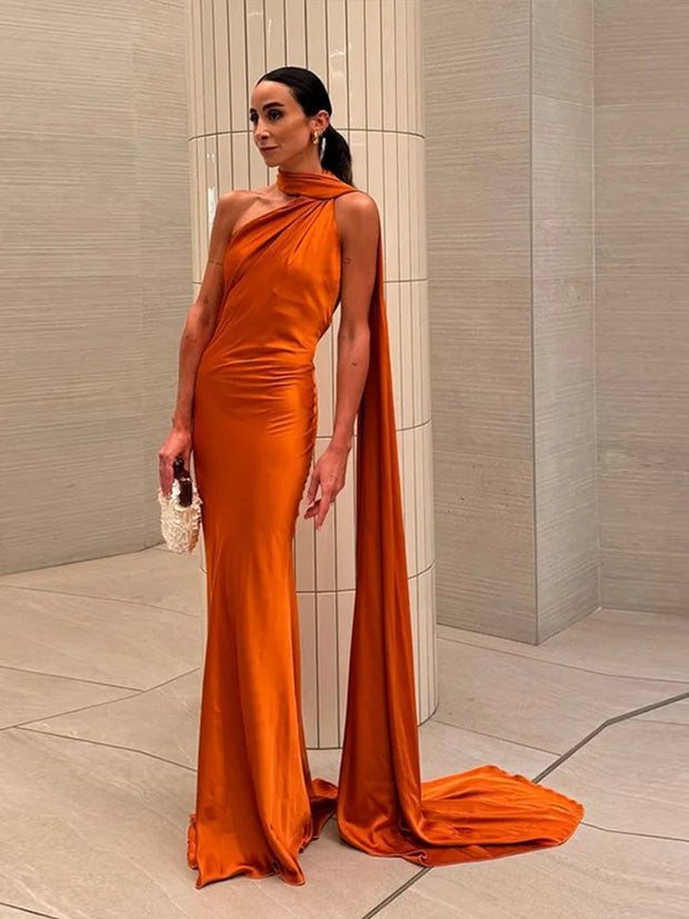 woman wearing orange halter backless off shoulder sleeveless ankle-length gown with diagonal collar and slim fit