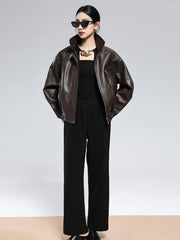 Woman wearing brown PU leather turn-down collar jacket with zipper and black pants