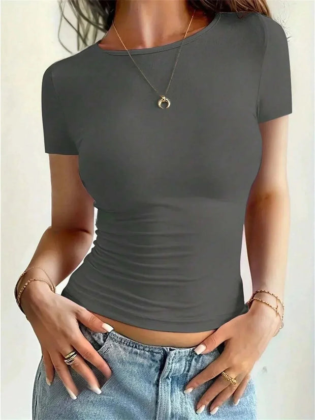 Women wearing solid gray summer fashion tee with short sleeves and round neck paired with denim jeans