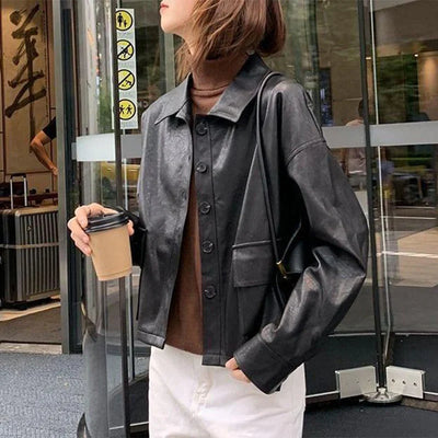 Women’s black faux leather single-breasted cropped jacket with turn-down collar and pockets, autumn fashion moto biker style
