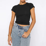 Woman wearing solid black summer fashion tee with short sleeves and round neck paired with blue jeans