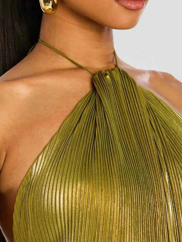 close-up of sleeveless backless lady robe with halter neckline in metallic green pleated fabric