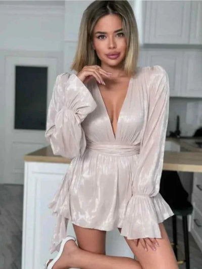 woman wearing chic long sleeves ribbon vestidos mini dress with deep v-neck and ruched waist in a modern kitchen