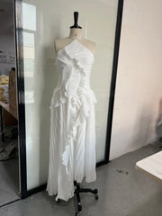 White slim fit backless halter dress with lace-up detail and ruffled design on mannequin