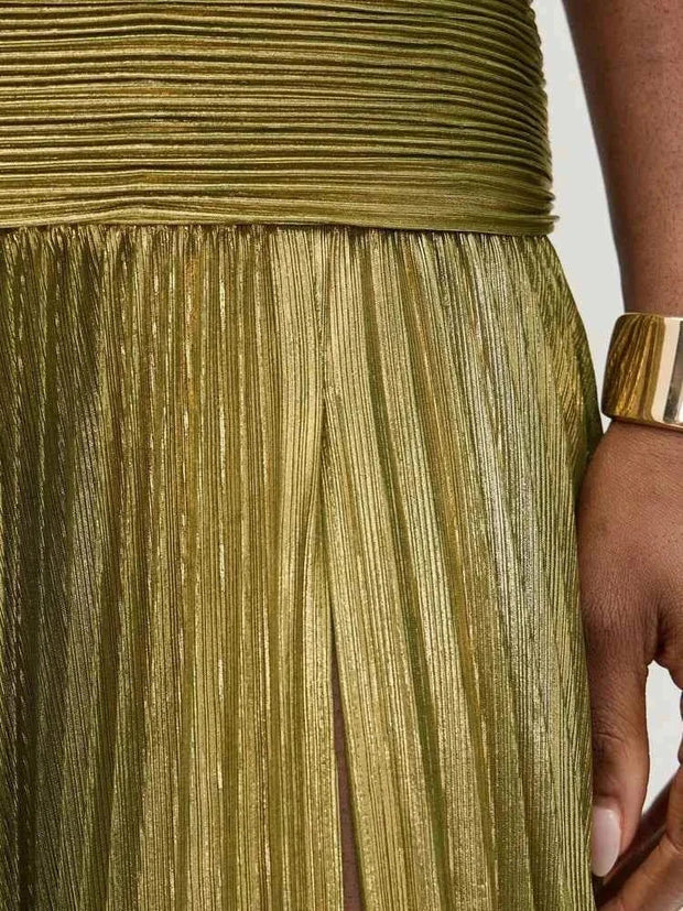 Close-up of pleated gold sleeveless backless lady robe fabric with zipper and fitted waist detail